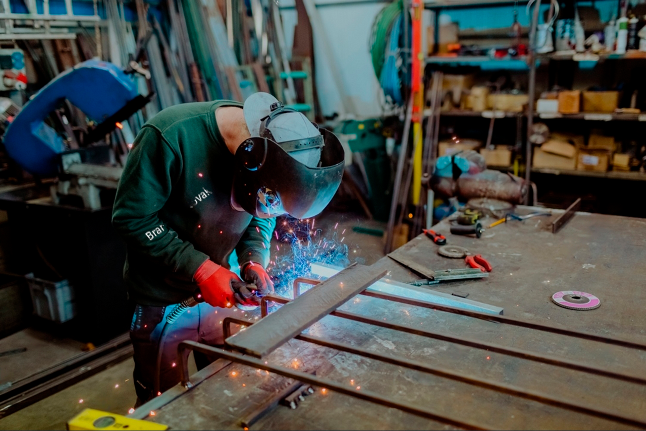 stock-photo-welder-welding-metal-at-workshop-welder-wearing-welding-helmet-working-with-welding-torch-in-2121122558-transfor